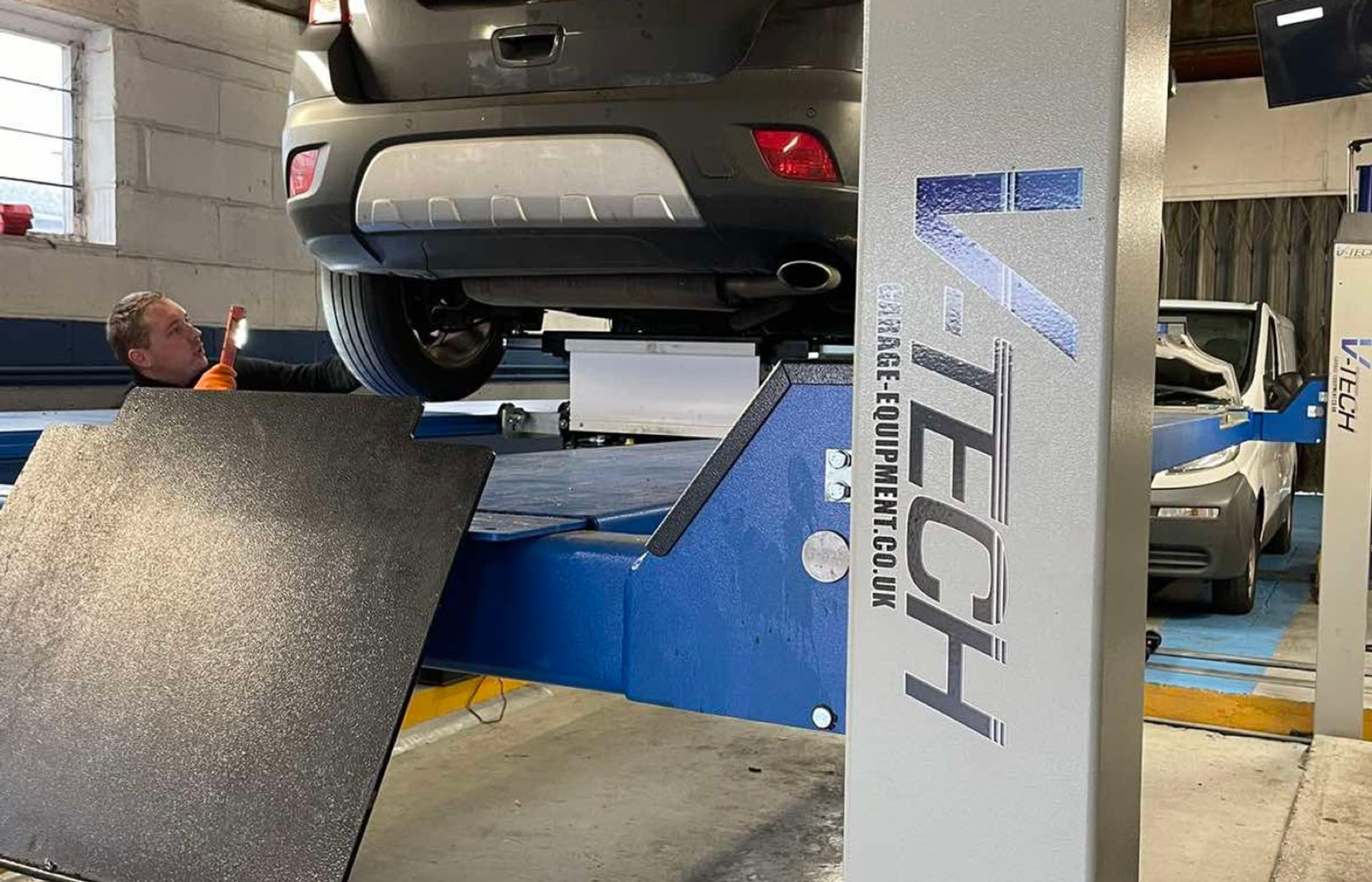 Vehicle on the lift in the LNC Motors workshop